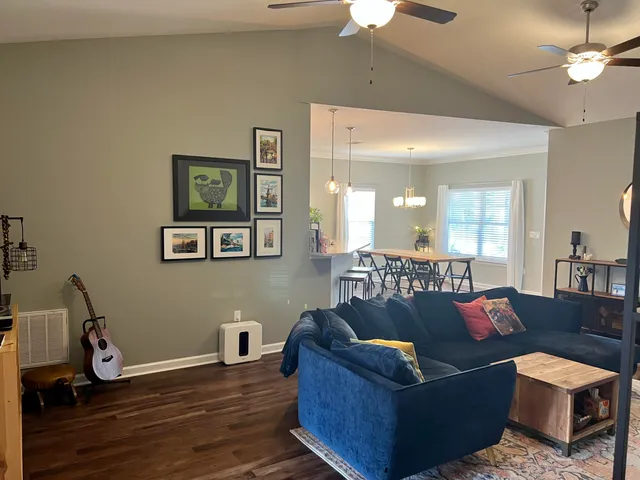 a living room with furniture and wooden floor