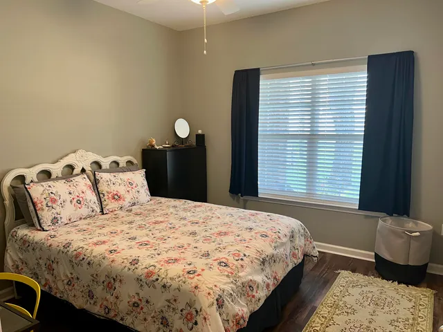 a bedroom with a bed and a window