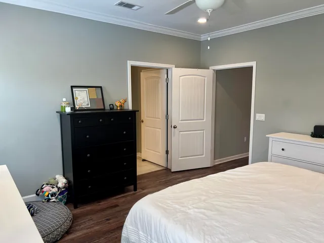 a bedroom with a bed and a dresser