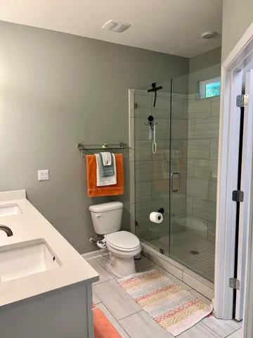 a bathroom with a toilet sink and shower