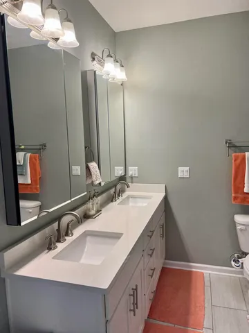 a bathroom with a double vanity sink and a mirror