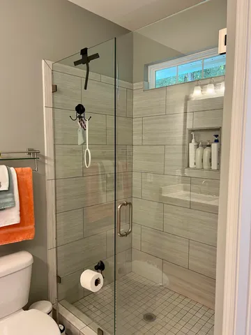 a bathroom with a shower and toilet