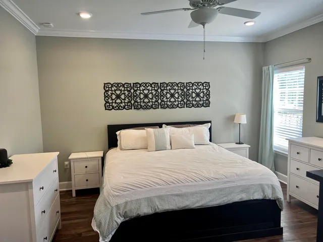 a bedroom with a large bed and a chandelier