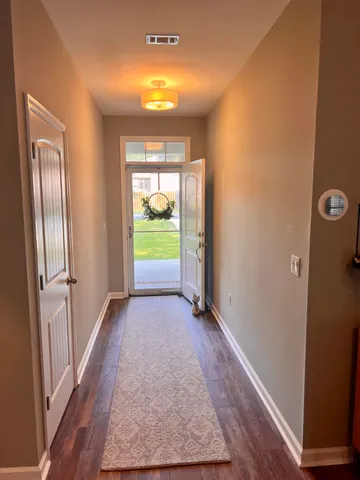 an empty room with closet and wooden floor