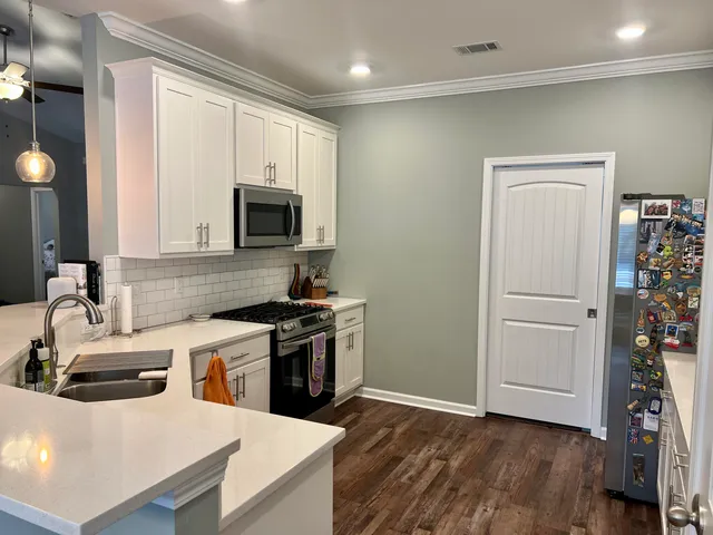 a kitchen with a refrigerator sink and stove