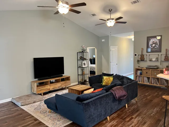 a living room with furniture and a flat screen tv
