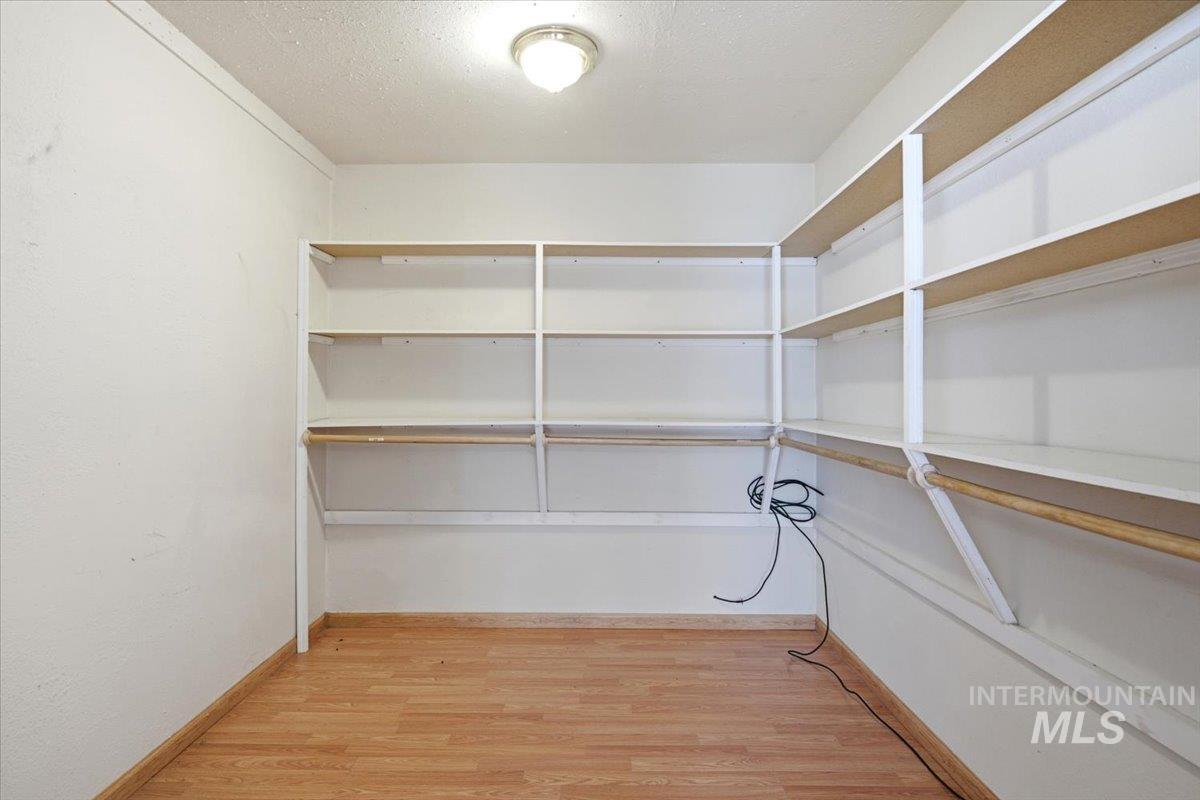 3929-3927 Homestead Road Homedale, ID 83628 - Photo 38 of 45 Built-in shelving units, wood-finish flooring, overhead flush mount lighting