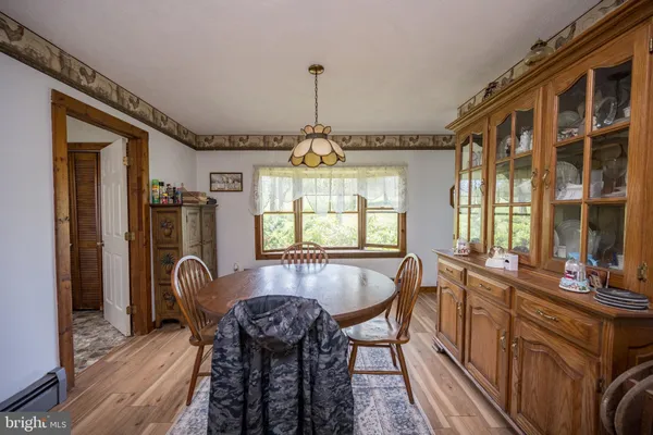 a dining room with furniture window and wooden floor