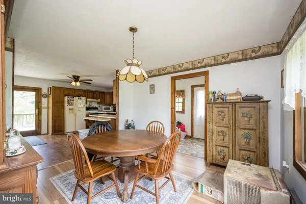 a living room with furniture and a ceiling fan
