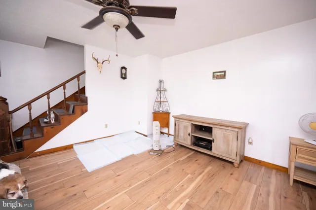 a view of a hallway with wooden floor and entryway