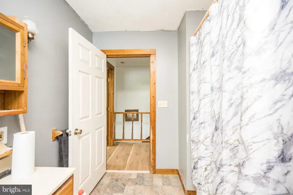 a living room with furniture a flat screen tv and a wall painting