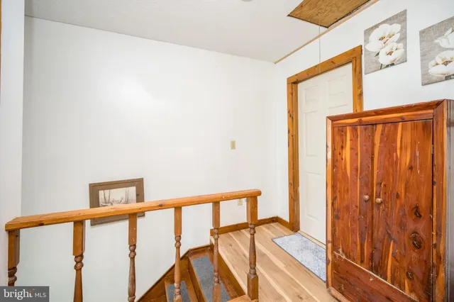 a bedroom with a bed and a wooden floor