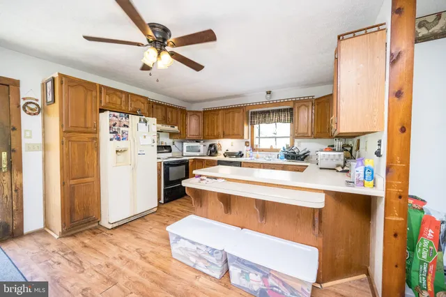 a kitchen that has a sink and a stove in it