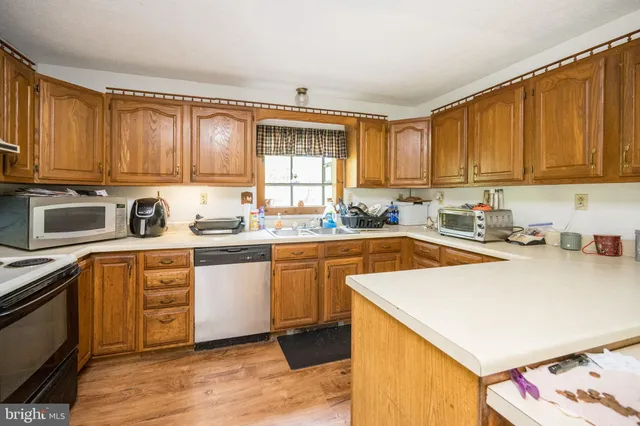 a kitchen with stainless steel appliances granite countertop a sink and cabinets
