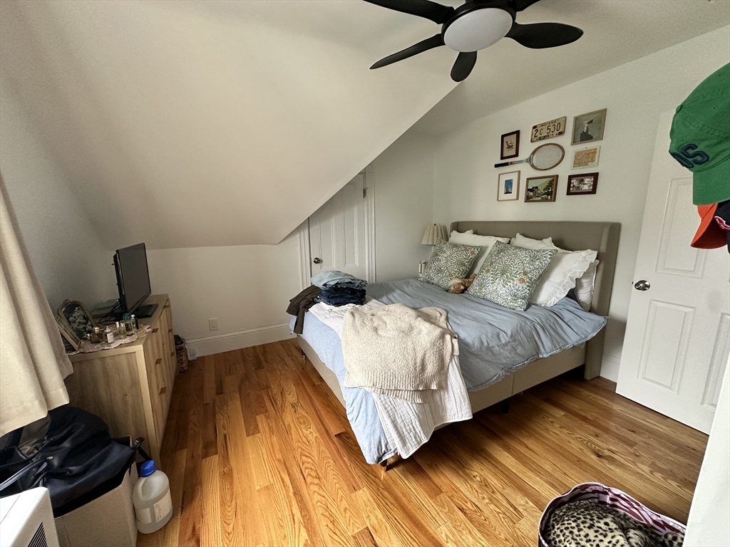 175 Everett Street, Unit 1 Boston, MA 02134 - Photo 21 of 25 a bedroom with a bed and wooden floor