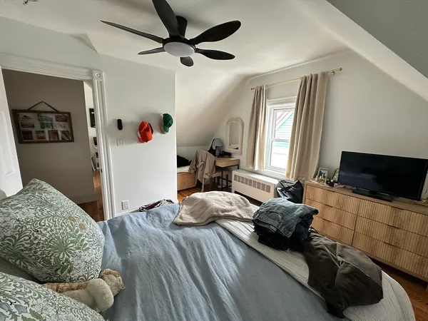 a bedroom with a bed and a flat screen tv