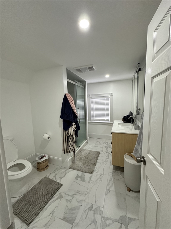 175 Everett Street, Unit 1 Boston, MA 02134 - Photo 23 of 25 a bathroom with a toilet sink and mirror