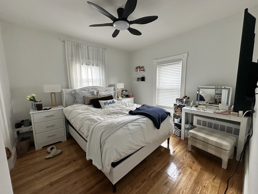 175 Everett Street, Unit 1 Boston, MA 02134 - Photo 25 of 25 a bedroom with a bed and wooden floor