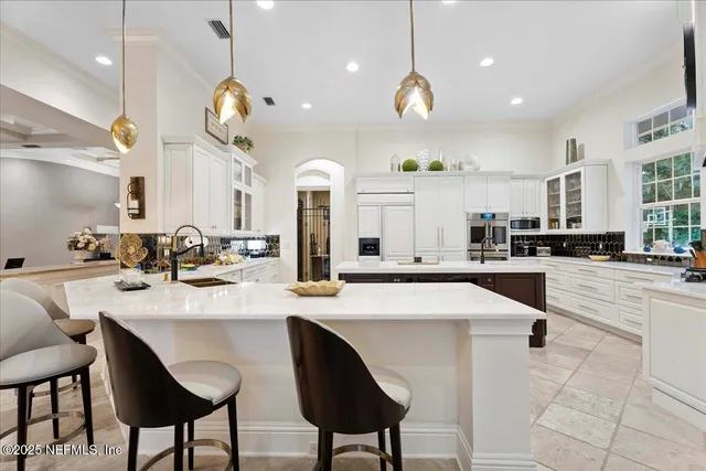 a view of a dining room with furniture and a chandelier