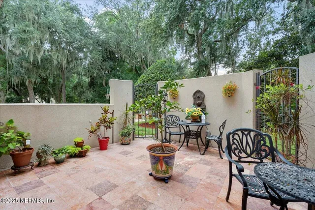 a backyard of a house with table and chairs