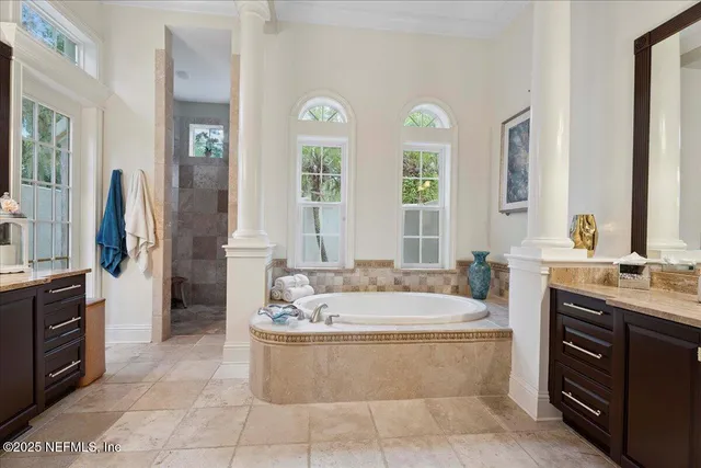 an aerial view of residential houses with outdoor space and lake view