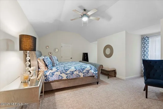 an aerial view of ocean and residential houses with outdoor space and swimming pool