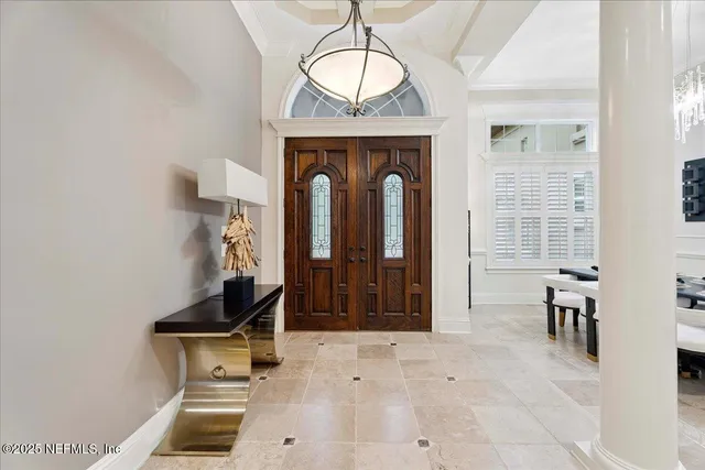 a living room with furniture and a floor to ceiling window