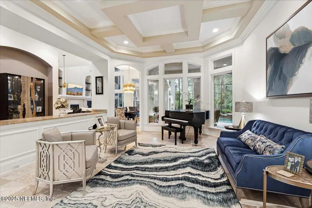 a view of a dining room with furniture and chandelier