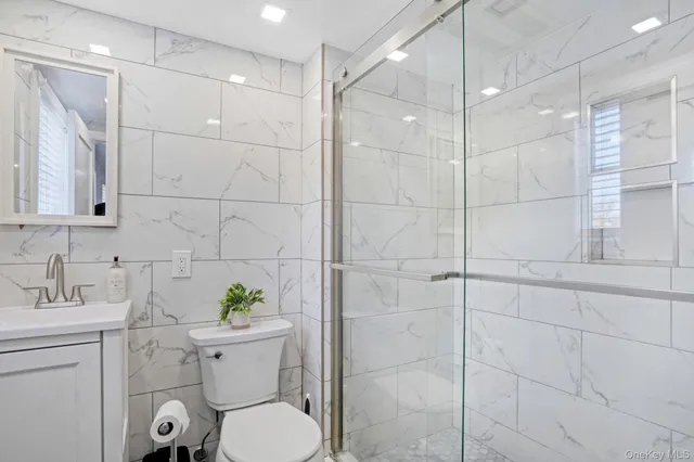 a bathroom with a toilet sink and shower