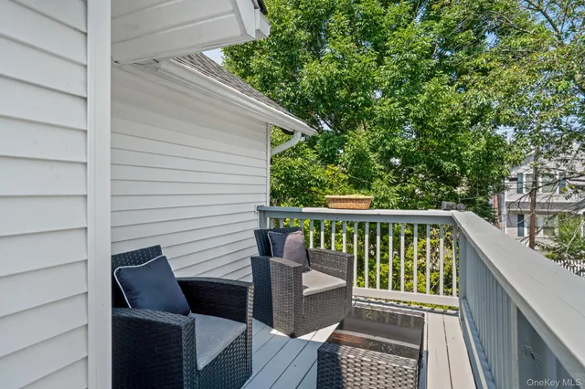 a view of balcony with wooden floor and outdoor seating