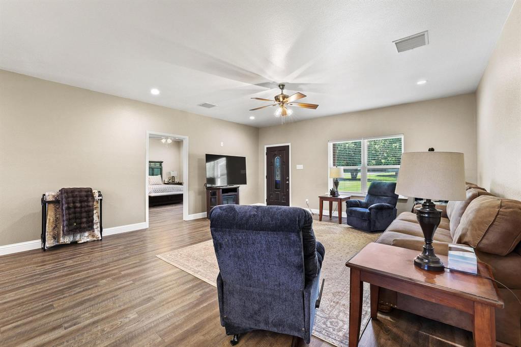 2658 Oak Ridge Road Denison, TX 75021 - Photo 6 of 37 a living room with furniture a ceiling fan and a window