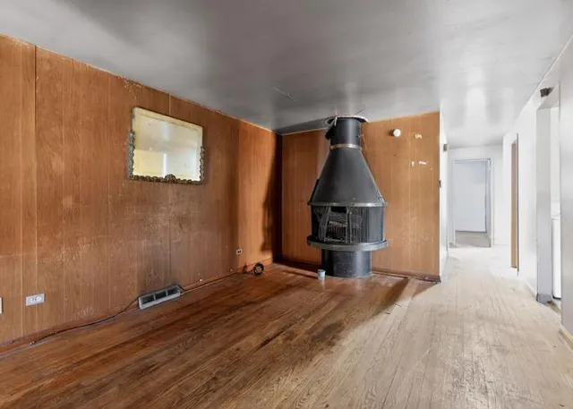 a view of a room with wooden floor and staircase