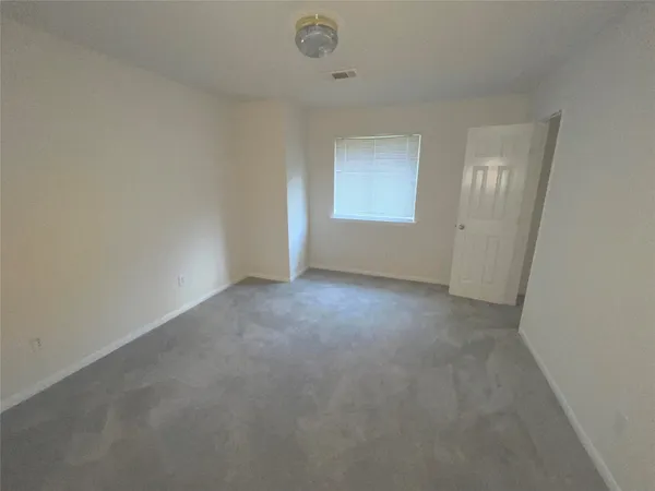 a view of a backyard with a small cabin and wooden fence