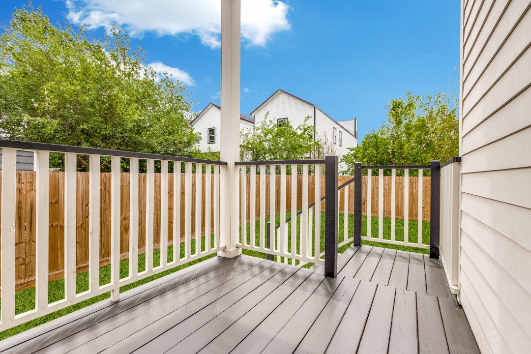728 East 38th Street Houston, TX 77022 - Photo 16 of 18 Cozy backyard deck with sleek railings overlooking a spacious yard, offering the perfect setting for outdoor relaxation, entertaining, or gatherings.