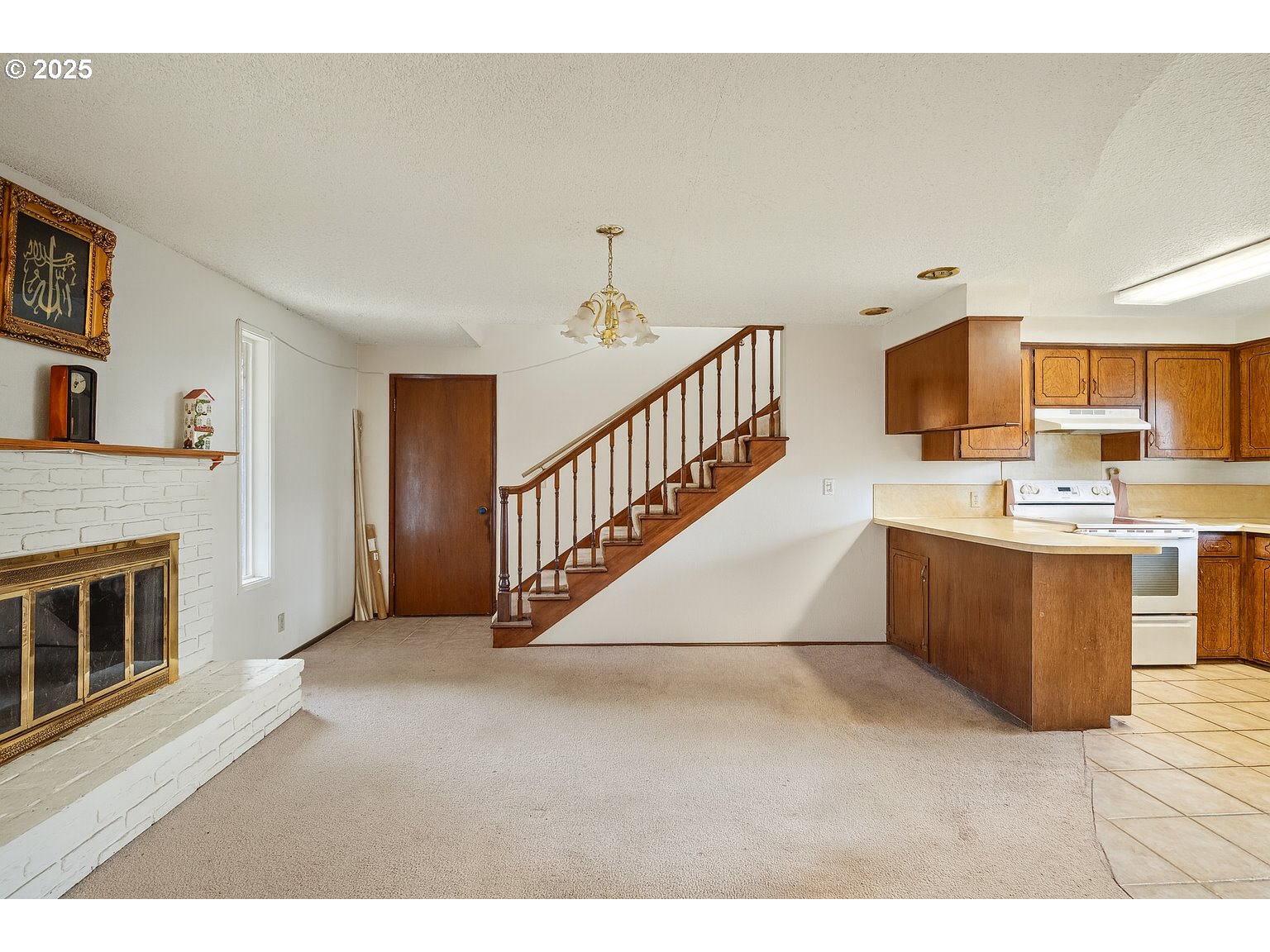 1429 Delrose Avenue Springfield, OR 97477 - Photo 3 of 21 a view of kitchen with kitchen island microwave stove refrigerator and cabinets