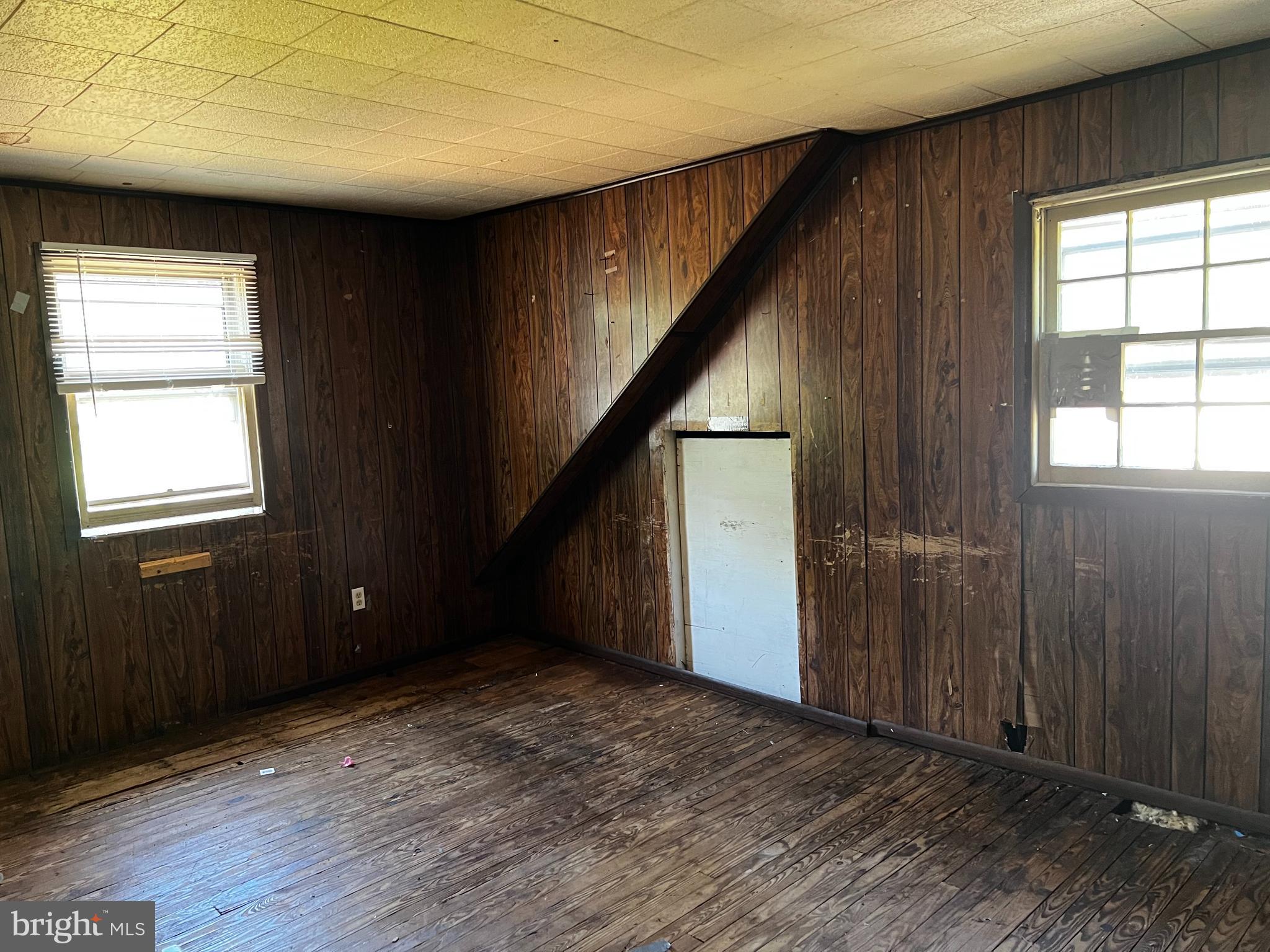 41 Churchtown Road Pennsville, NJ 08070 - Photo 16 of 20 an empty room with wooden floor and windows