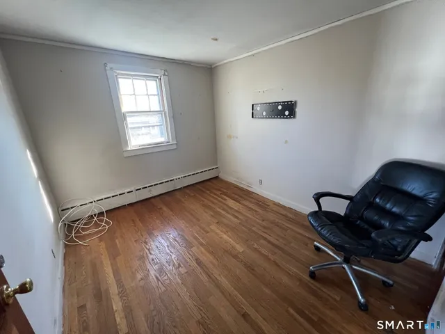 a room with wooden floor and windows
