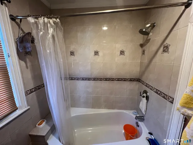 a bathroom with a tub and a shower