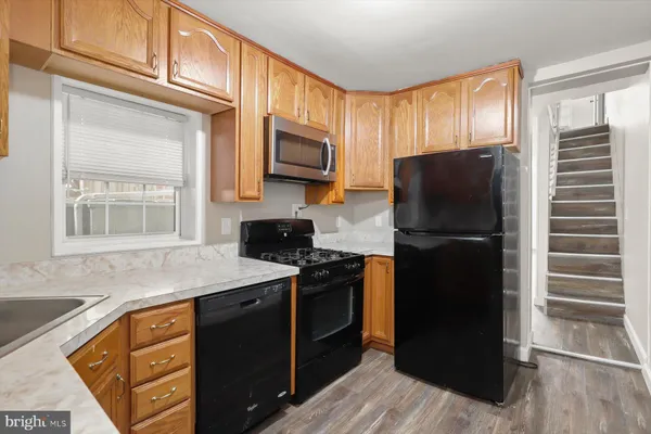 a kitchen with a refrigerator stove and microwave