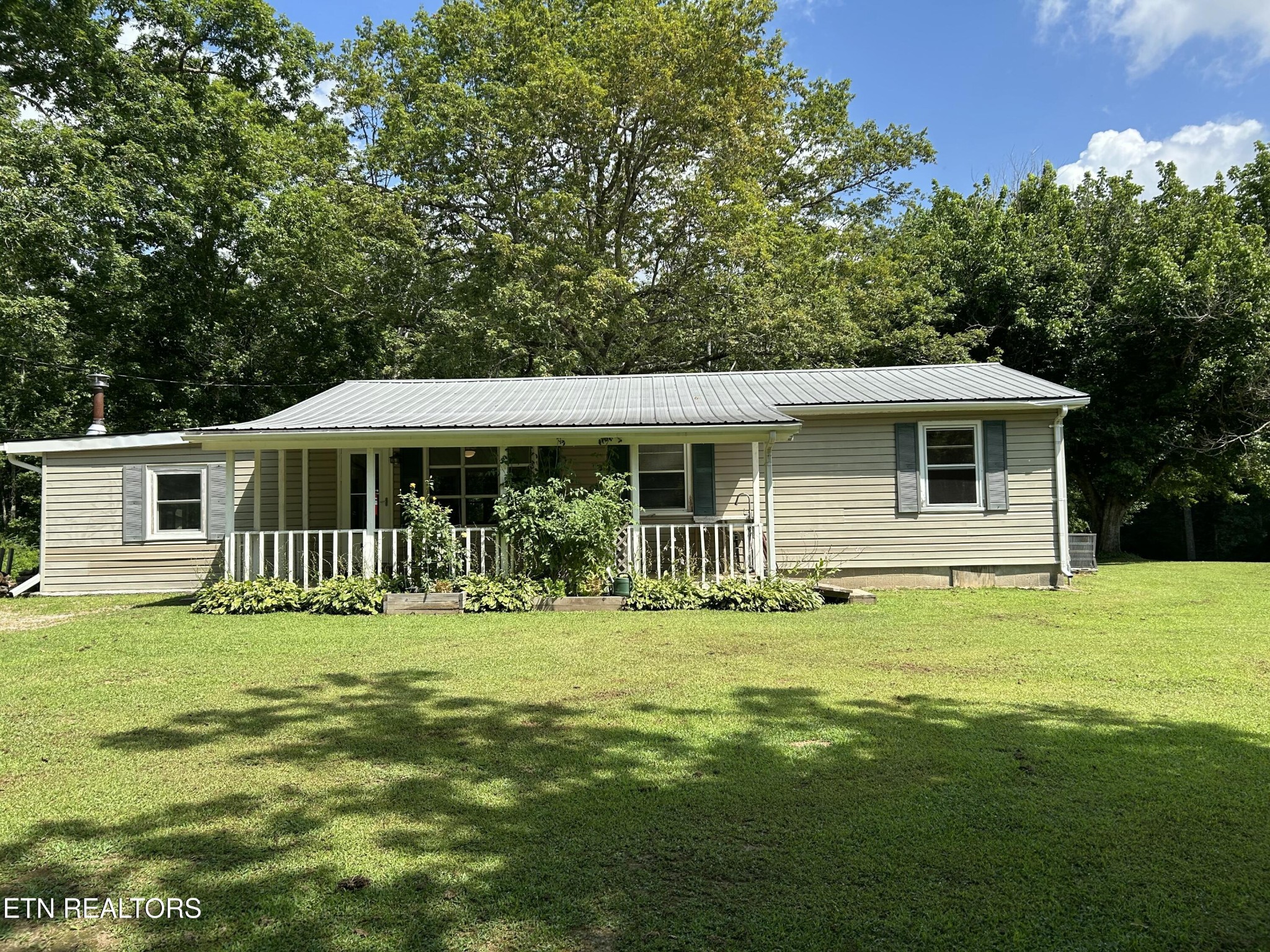 481 George Smith Road Crossville, TN 38571 - Photo 1 of 1 a front view of a house with a garden