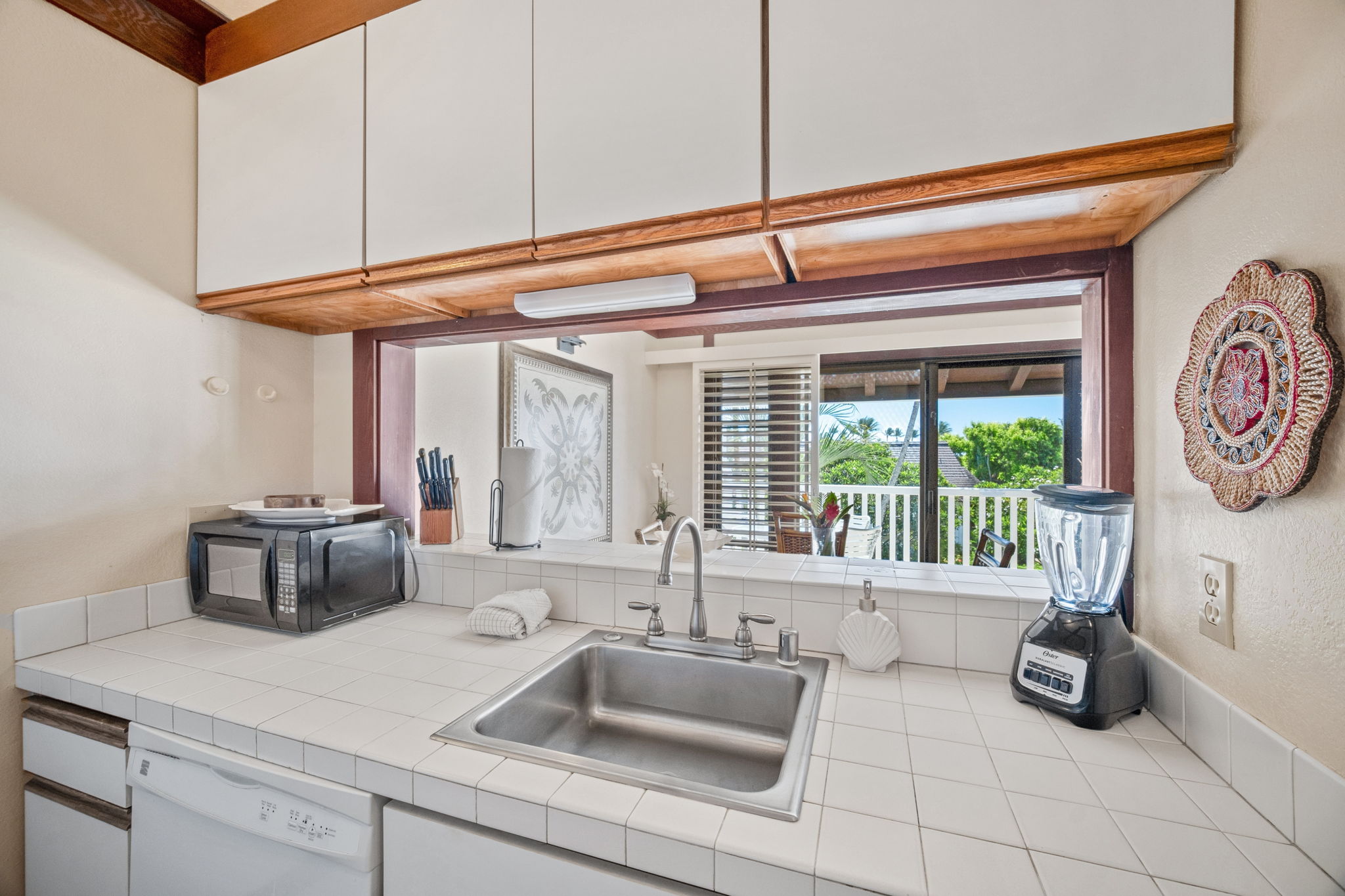 2253 Poipu Road, Unit 109 Koloa, HI 96756 - Photo 14 of 30 a kitchen with a sink and a refrigerator