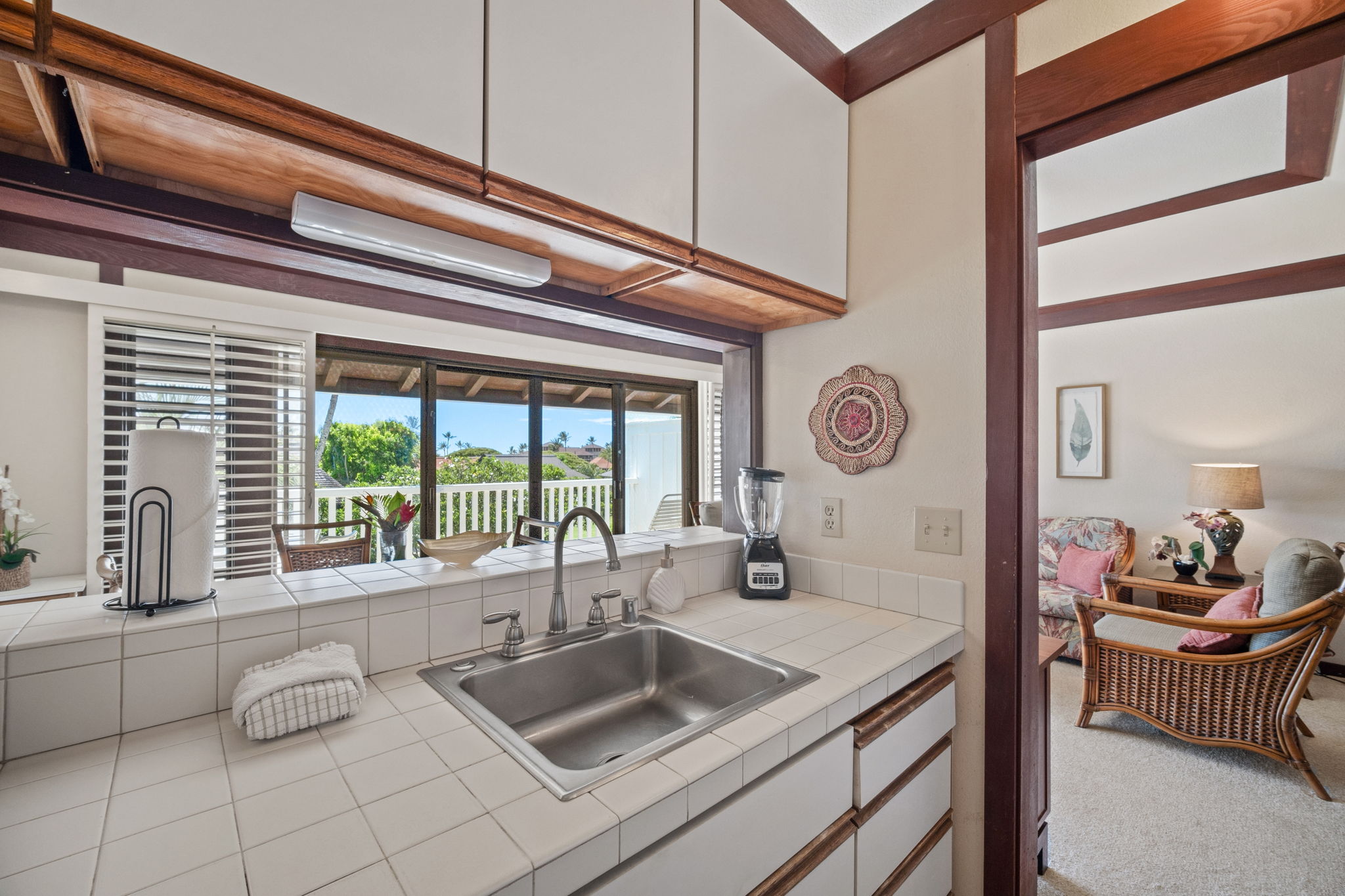 2253 Poipu Road, Unit 109 Koloa, HI 96756 - Photo 16 of 30 a kitchen with a sink and a clock on the wall