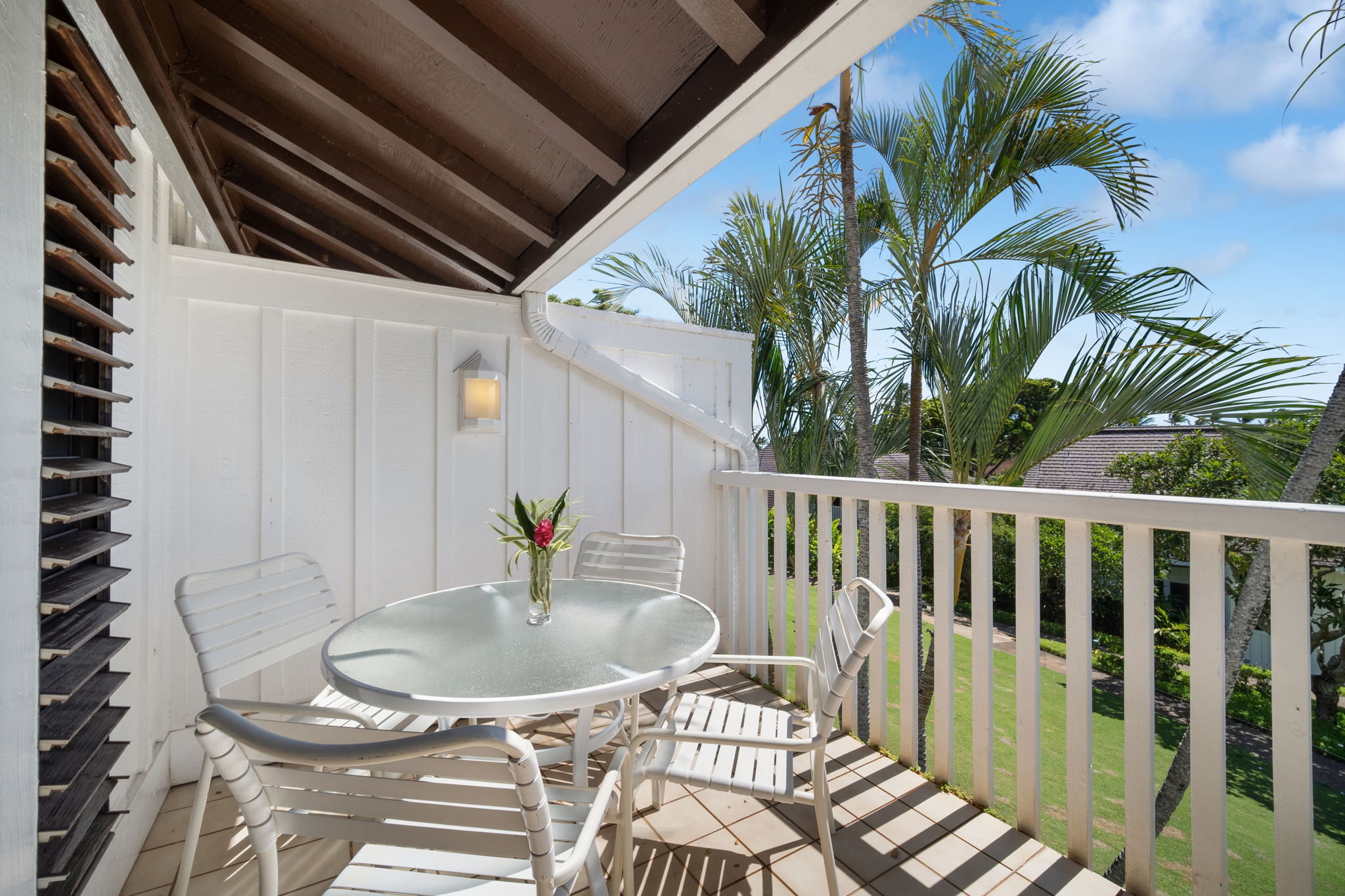 2253 Poipu Road, Unit 109 Koloa, HI 96756 - Photo 23 of 30 a balcony with table and chairs