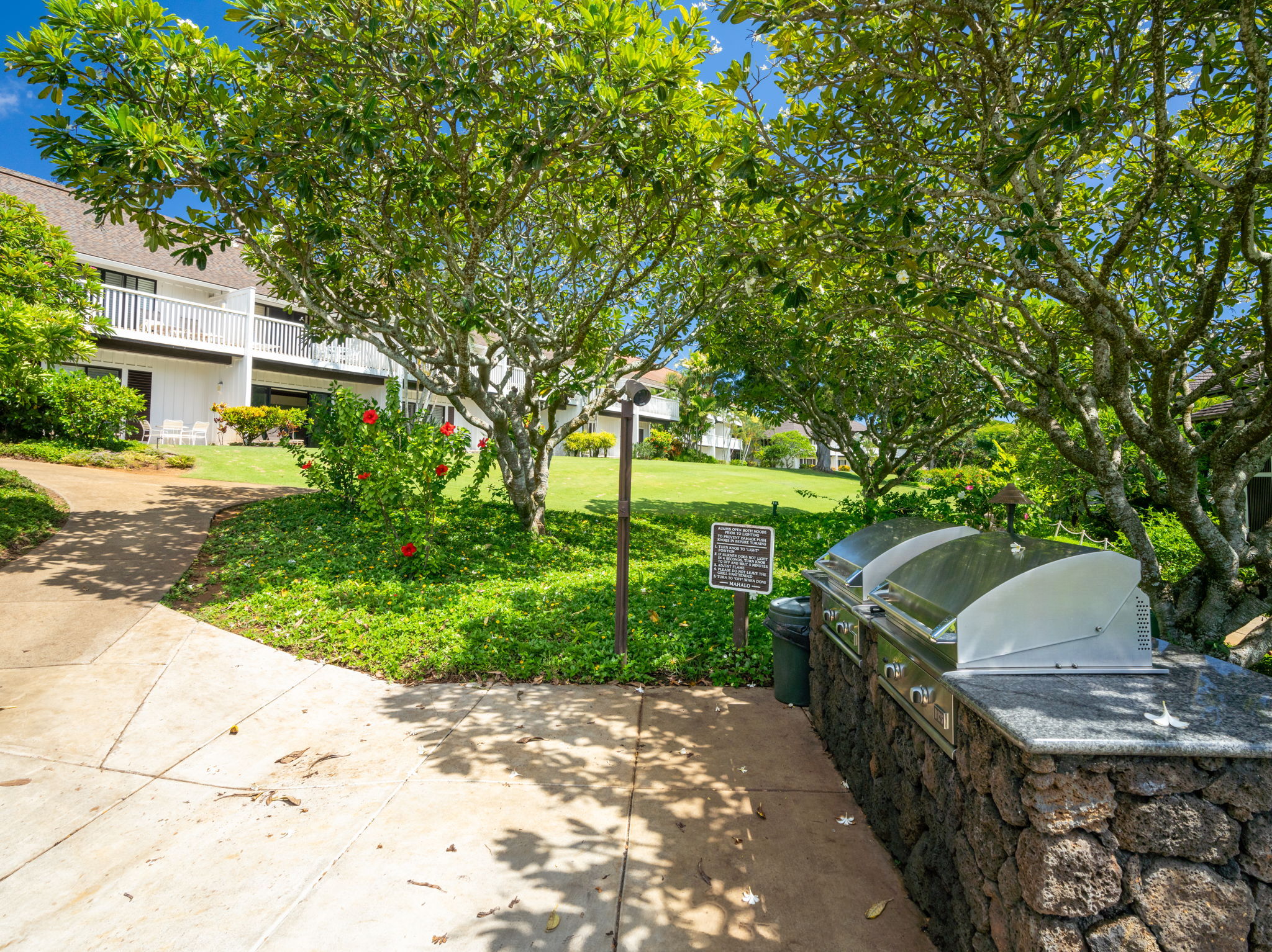 2253 Poipu Road, Unit 109 Koloa, HI 96756 - Photo 26 of 30 a view of a patio with table and chairs and potted plants