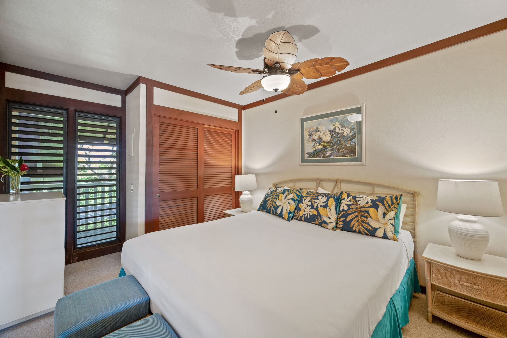 2253 Poipu Road, Unit 109 Koloa, HI 96756 - Photo 3 of 30 a bedroom with a bed and a chandelier