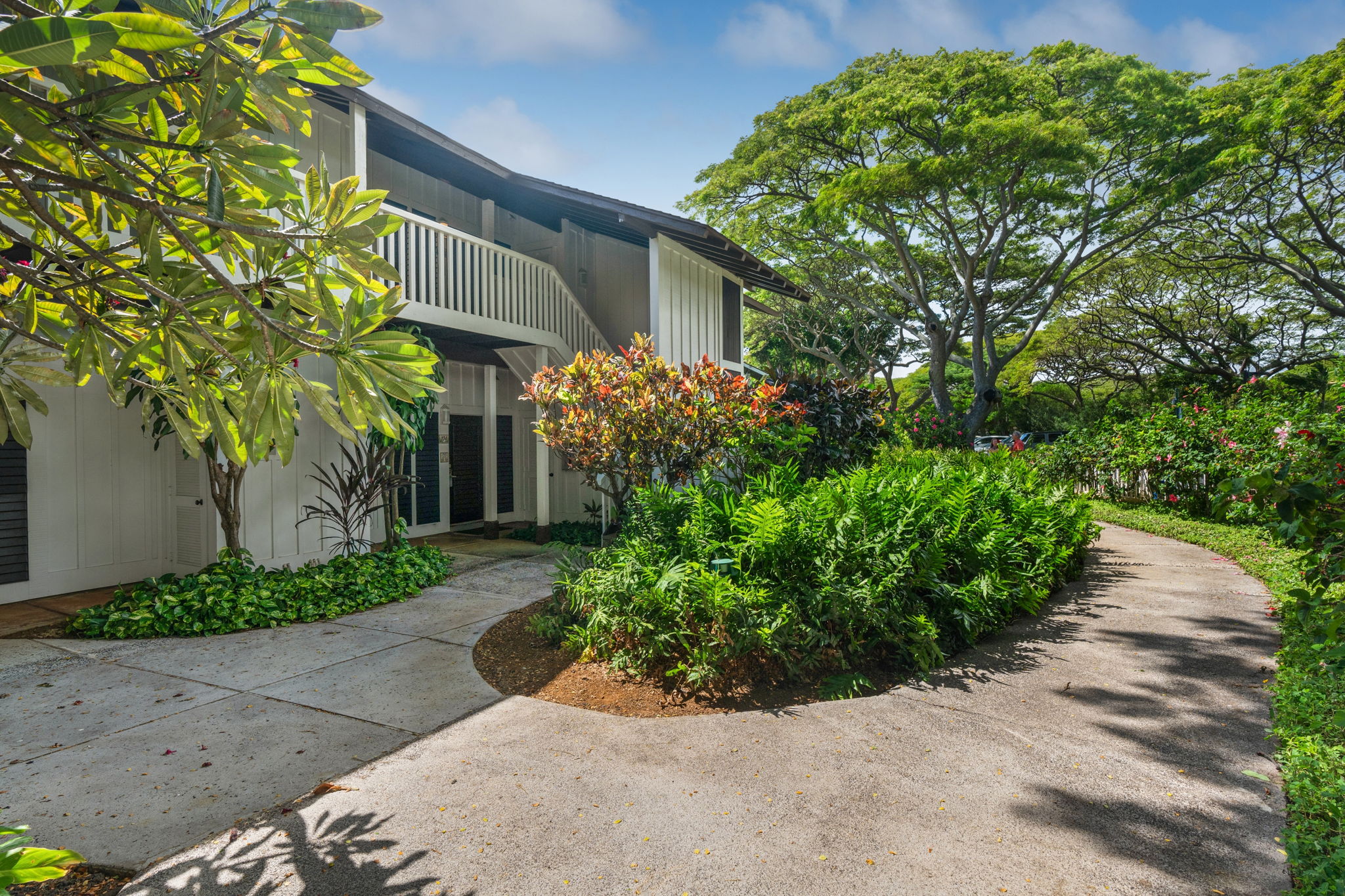 2253 Poipu Road, Unit 109 Koloa, HI 96756 - Photo 6 of 30 a front view of a house with a yard