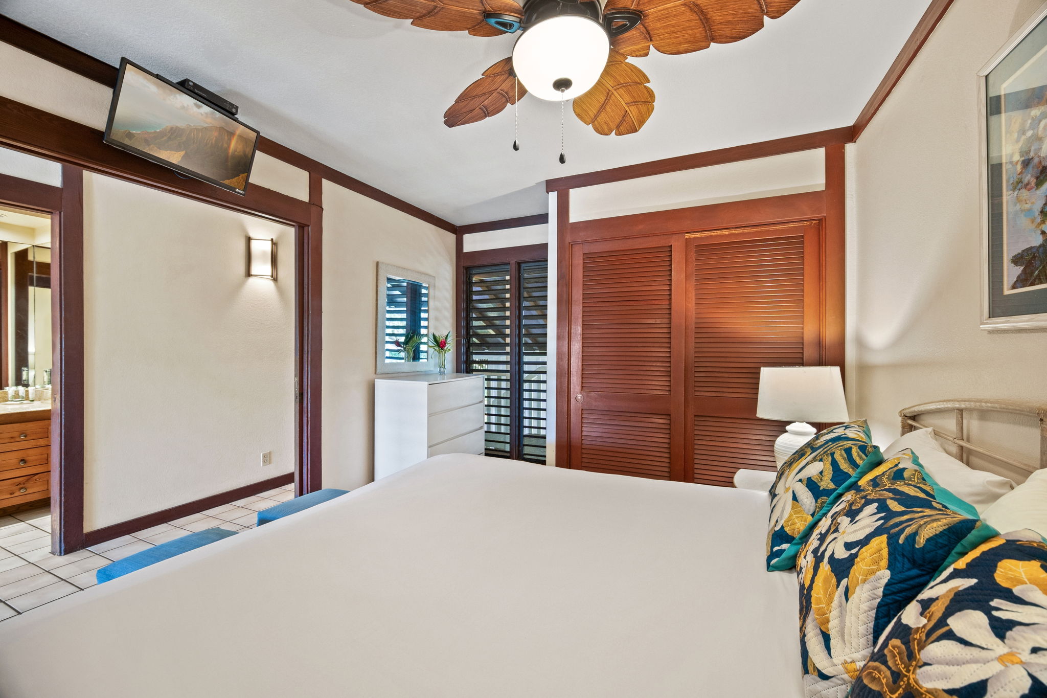 2253 Poipu Road, Unit 109 Koloa, HI 96756 - Photo 10 of 30 a bedroom with a bed and a chandelier