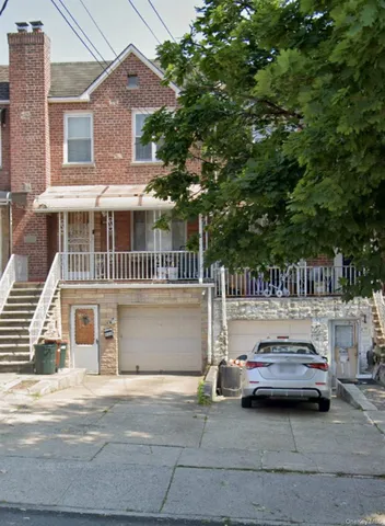 a white house covered with tall trees
