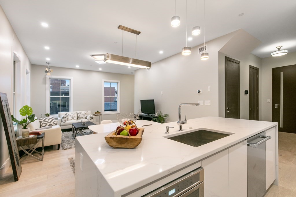 88 Dover Street, Unit 2 Somerville, MA 02144 - Photo 1 of 36 a kitchen with a sink a stove and chairs