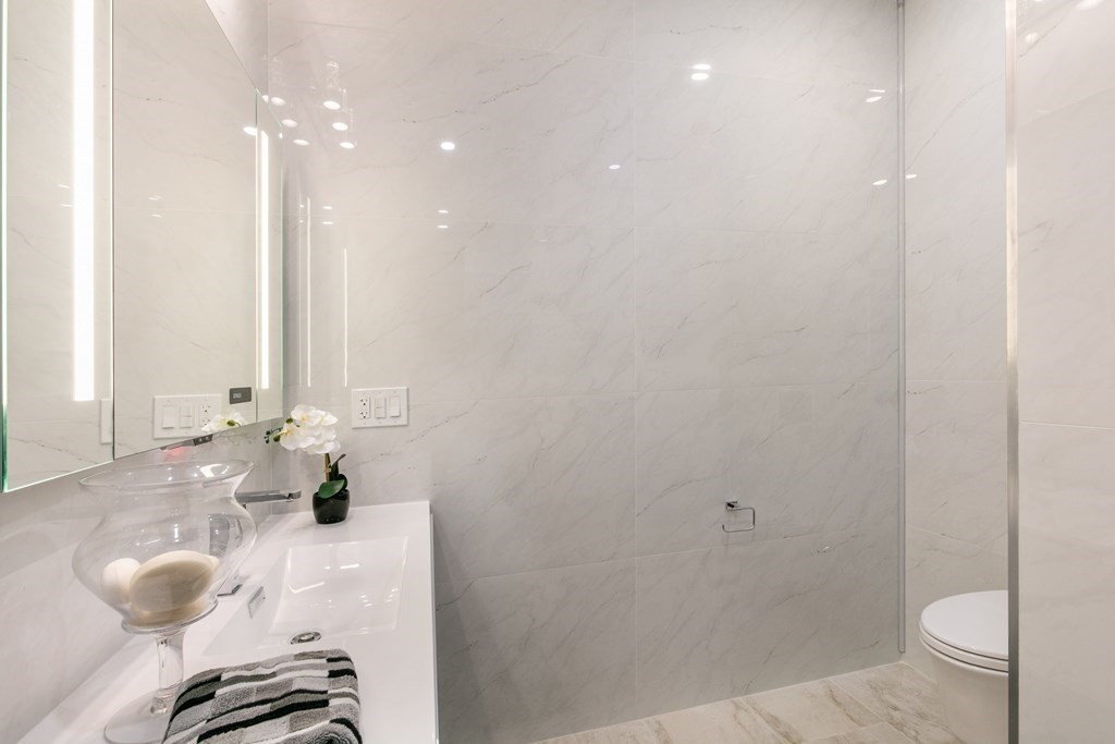 88 Dover Street, Unit 2 Somerville, MA 02144 - Photo 15 of 36 a bathroom with a granite countertop sink and a mirror